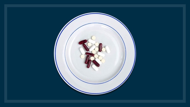 weight loss pills on a plate navy background